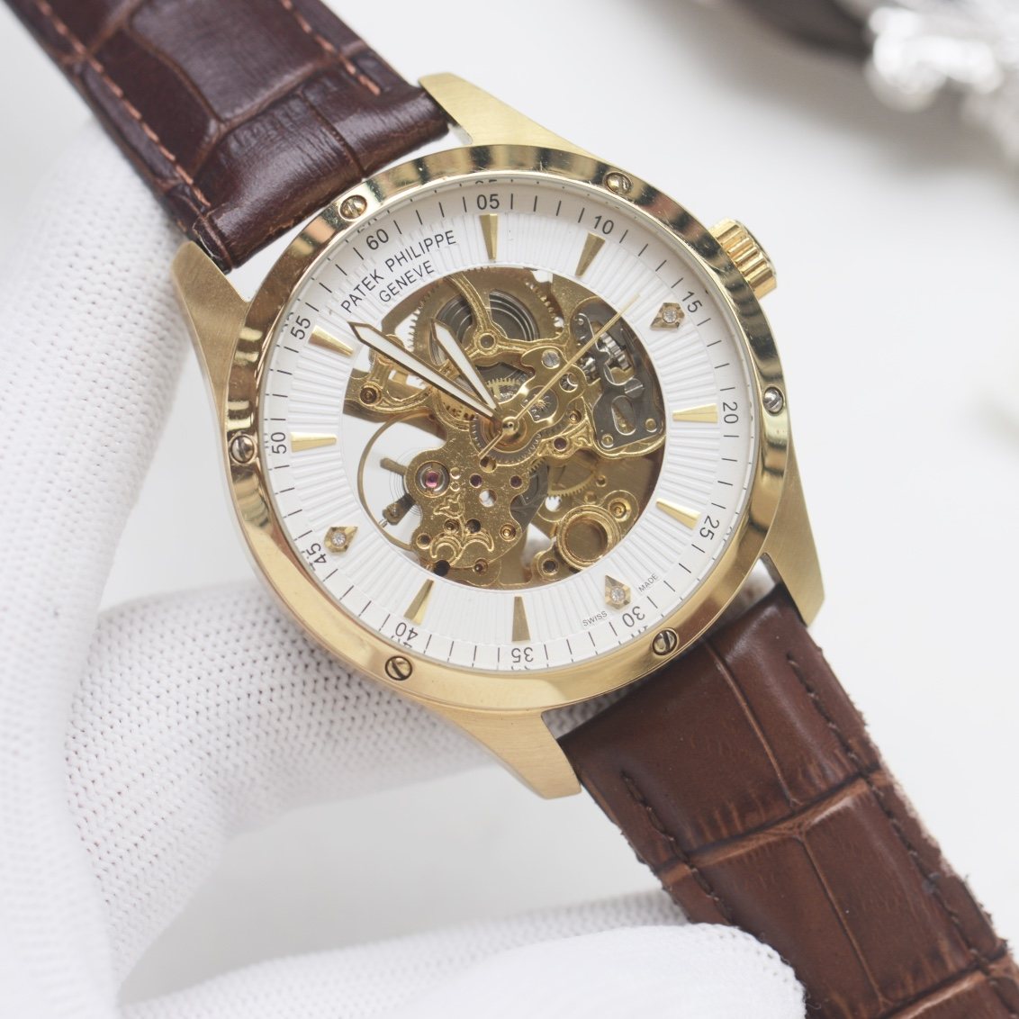 Patek Philippe Gold White Strap Watch — hero